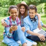 happy-students-enjoying-break-on-green-lawn.jpg